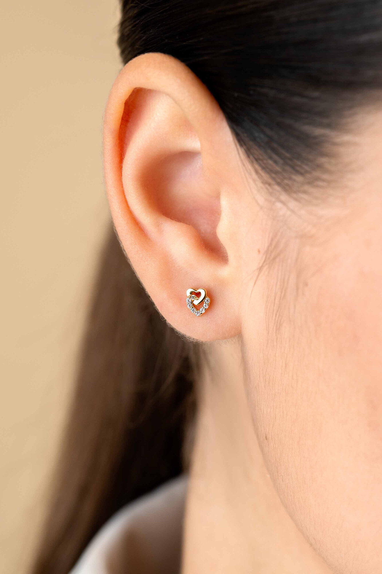 ZINZI GOLD oorknopje 2 hartjes inelkaar 1 bezet zirc.