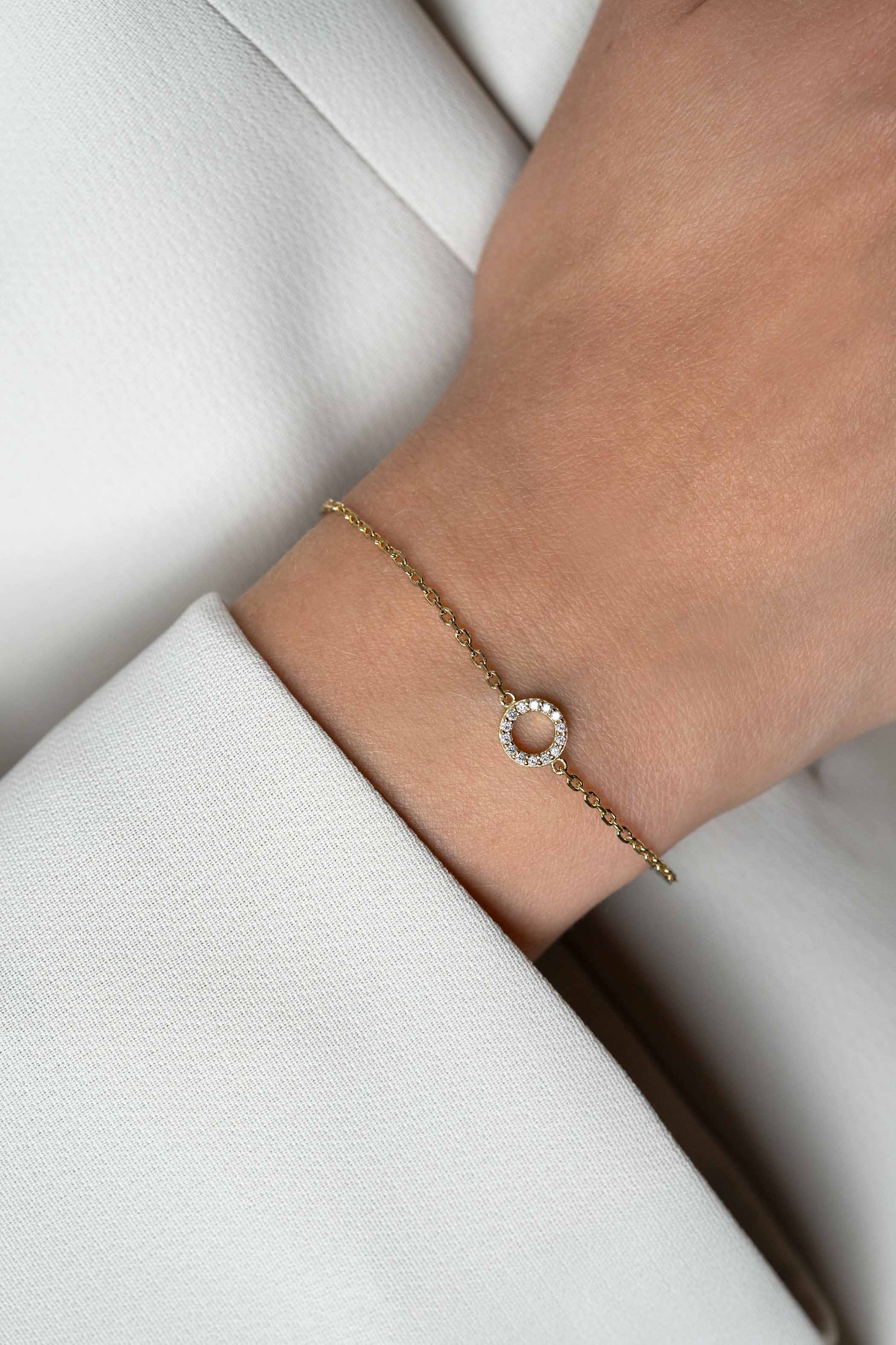 ZINZI zlv. armband gg.verg. open rondje bezet zirc.